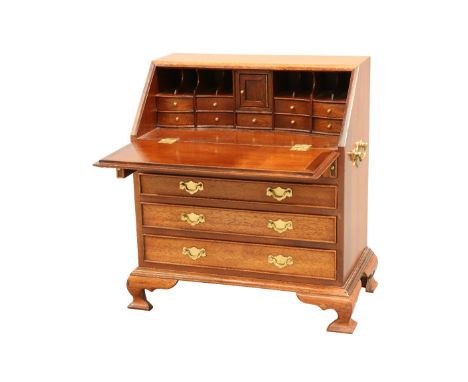 A GEORGIAN STYLE MAHOGANY MINIATURE BUREAU, with slant-front above two short over three long graduated drawers, fitted with b