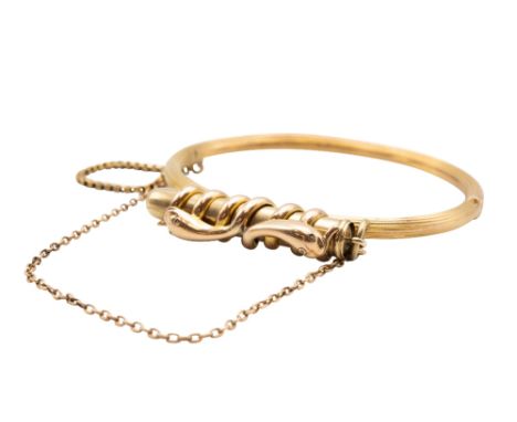 A LATE 19TH CENTURY BANGLE WITH ATTACHED PROPELLING PENCILThe hinged bangle of reeded finish, fitted with a wire frame mount 