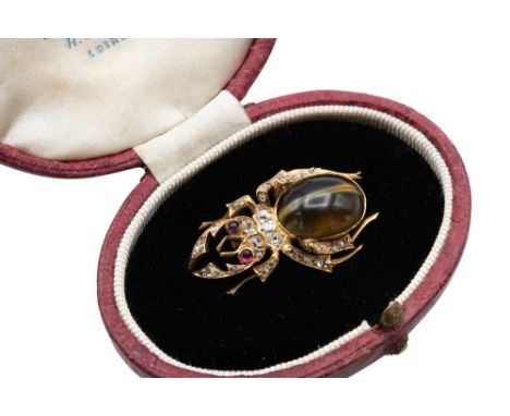 A LATE 19TH CENTURY CAT'S EYE CHRYSOBERYL, RUBY AND DIAMOND BEETLE BROOCHRealistically modeled as a beetle, set throughout wi