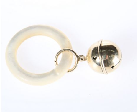 A GOLD BABY'S RATTLE, the bell loop stamped 14K, on a mother-of-pearl teething ring.Some very minor bruising to the rattle bu