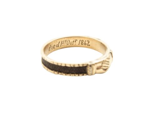 A HAIRWORK MOURNING RING, CIRCA 1862Designed as a pair of clasped hands, to ridged hoop inset with a band of plaited hair, th