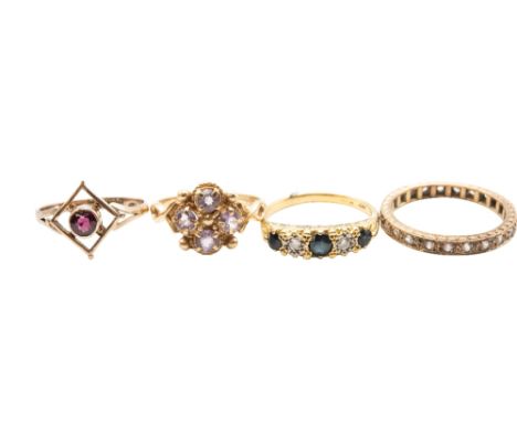 A collection of four yellow gold and gem set rings, including an 18ct ring set with single round cut garnet in square shaped 