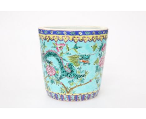 A CHINESE FAMILLE ROSE PORCELAIN JARDINIERE, enamel painted with four-claw dragon and phoenix against a turquoise ground. 20.