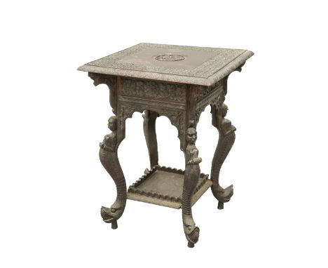 A MOORISH CARVED HARDWOOD TABLE, 19TH CENTURY, the square top with trestle type design of flowerheads and centred by the figu