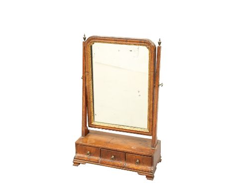 AN 18TH CENTURY WALNUT TOILET MIRROR, the mirror plate in a cushion moulded frame with gilt slip, the base with three concave