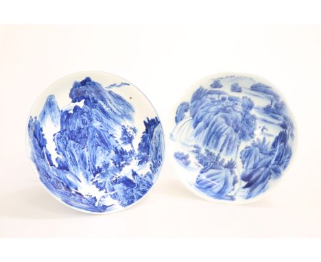 TWO CHINESE BLUE AND WHITE PORCELAIN BOWLS, one painted to the well with a mountainous landscape, the other buildings in a wo