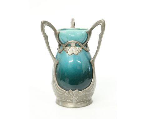 A SECESSIONIST PEWTER-MOUNTED POTTERY VASE, CIRCA 1900, the shaded blue-glazed body with undulating neck, the pewter mount ca