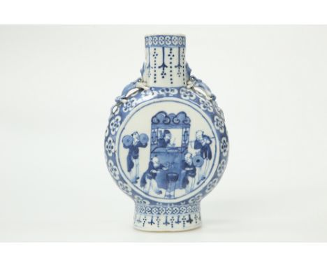 A CHINESE BLUE AND WHITE PORCELAIN MOON FLASK, 19TH CENTURY, of characteristic form, painted to each side with musicians, the