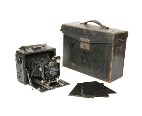 A VINTAGE GOERZ GERMAN FOLDING PLATE CAMERA, with Compur shutter and Dogmar lens, in leather case.