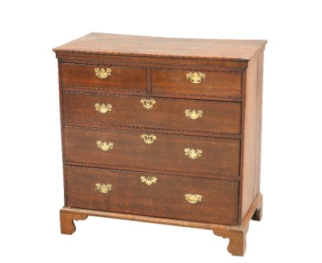 A GEORGE III OAK CHEST OF DRAWERS, with two short over three long graduated drawers, fitted with brass solid backplate handle