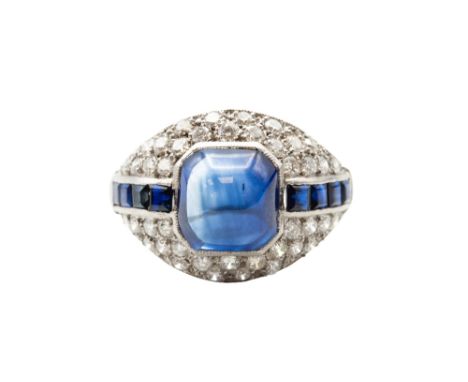 A SAPPHIRE AND DIAMOND DRESS RING Of bombé design, centred by an&nbsp;octagonal cabochon sapphire, within a surround of brill