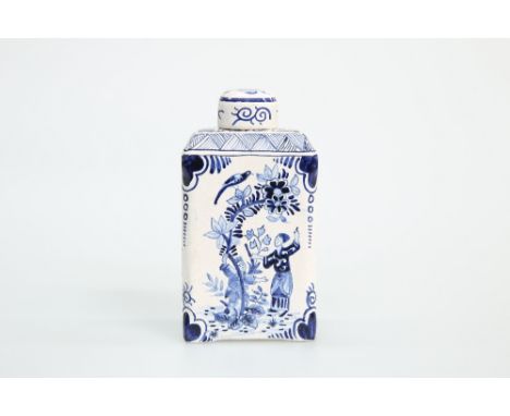 A DUTCH DELFT BLUE AND WHITE TEA CADDY AND COVER, c. 1800, painted to two sides with a female figure under a tree, the should