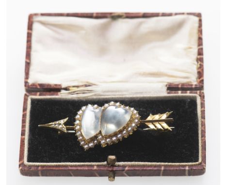 A MOONSTONE AND SEED PEARL BROOCH, CIRCA 1895Designed as a double-heart atop an arrow, set with heart-shaped cabochon moonsto