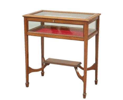 AN EDWARDIAN SATINWOOD INLAID MAHOGANY BIJOUTERIE TABLE, the rectangular case raised on square-section tapering legs joined b