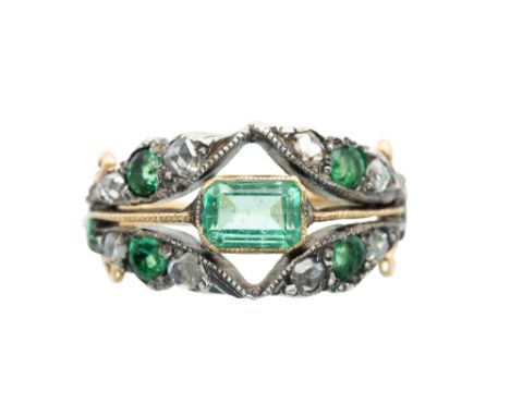 AN EMERALD AND DIAMOND RINGThe octagonal-cut emerald within an openwork surround, framed by circular-cut emeralds and rose-cu