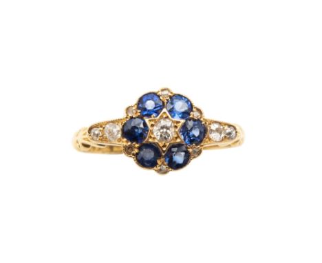 A SAPPHIRE AND DIAMOND CLUSTER RING, CIRCA 1923Centrally-set with an old brilliant-cut diamond, surrounded by circular-cut sa