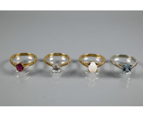 Four various 9ct rings one set oval aquamarine, size N, round zircon size M, oval pale opal size N, and oval ruby size N, app