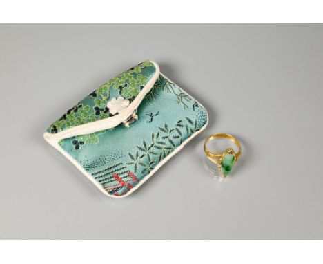 A marquis-shaped green jade set ring, unmarked yellow metal, with engraved shoulders, size M  