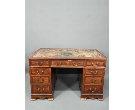 Maple &amp; Co. Ltd. a Victorian mahogany twin pedestal desk, the battered leather top over nine drawers, on shaped bracket f
