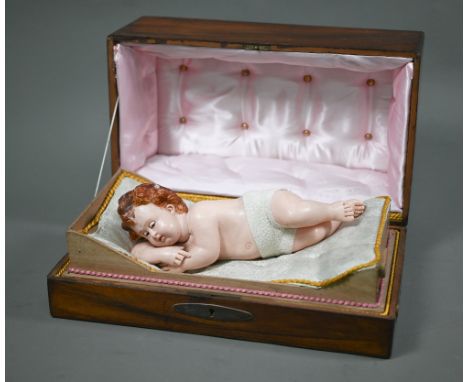 A 19th century Continental musical Automaton-wax sleeping infant - wakes up and moves its head as though as to look at you, t