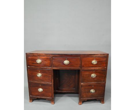 A Victorian mahogany bowfront kneehole desk, with six drawers and recessed cupboard, raised on splayed bracket feet, 118 cm x