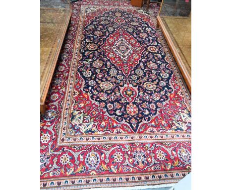 A contemporary central Persian Kashan carpet, the blue and red ground centred by a floral medallion, 345 cm x 200 cm  good ev