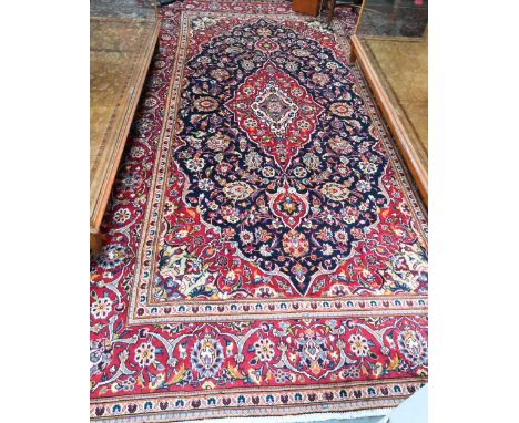 A contemporary central Persian Kashan carpet, the blue and red ground centred by a floral medallion, 345 cm x 200 cm  good ev