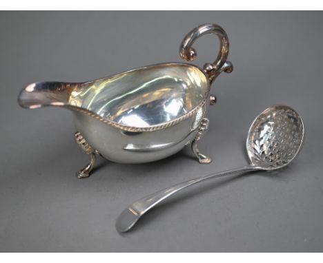 A George III silver old English pattern sifter ladle, Richard Crossley, London 1788, to/w a sauce boat in the Georgian manner