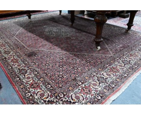 A Persian Bidjar red ground carpet, centred by a diamond floral lozenge, 335 cm x 247 cm  good even pile, clean