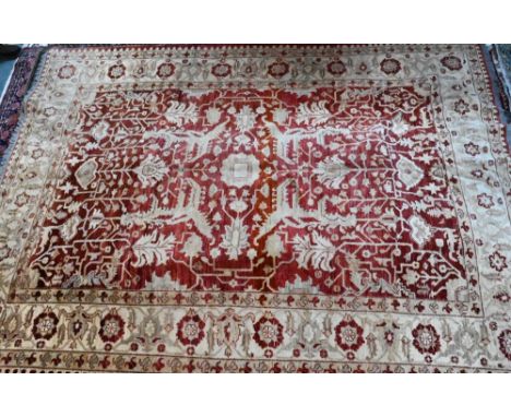 A contemporary Indian Agra carpet, the red-pink ground with stylised floral design, 323 cm x 242 cm  good even pile, colours 