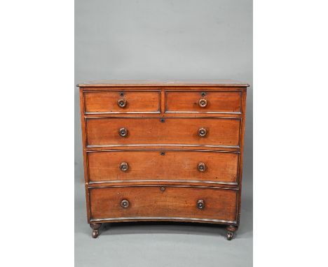 A Georgian mahogany concave chest of two short over three long graduated drawers, with turned handles, raised on (later) bun 