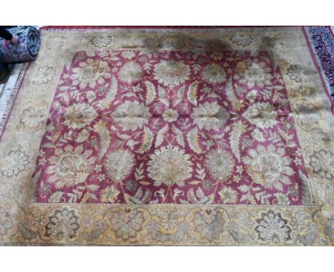 A contemporary Indo-Persian carpet, the wine-red ground with yellow-gold floral and leaf design, 304 cm x 238 cm  good even p