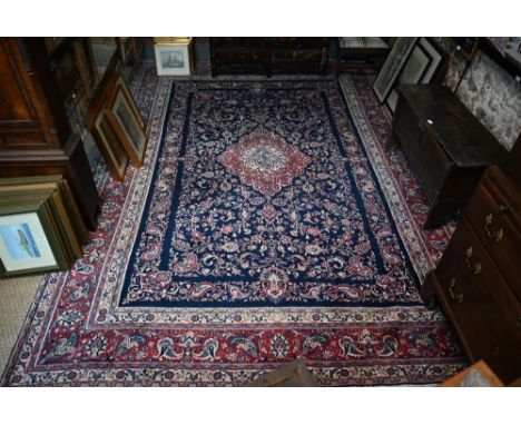 A fine Persian hand-made Tabriz carpet, the blue ground centred by a medallion, 368 cm x 265 cm  good clean, even pile