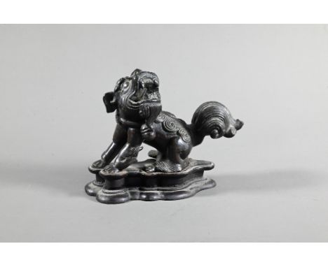 A 19th century Chinese bronze figure of a Buddhistic guardian lion, possibly an incense stand, Qing dynasty, 10 cm w x 7 cm h