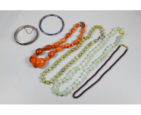 Row of graduated amber beads, two green aventurine bead necklaces, cloisonné bangle, silver oval half-hinged bangle and row o