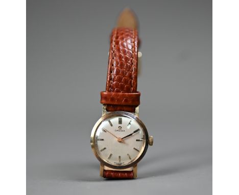 A vintage ladies Omega 9ct gold mechanical wristwatch on leather strap, circa 1967, the silvered dial with gilt baton markers