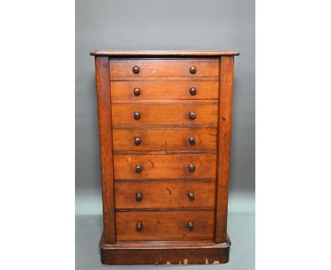 A Victorian mahogany Wellington chest of seven graduated drawers, with turned handles, raised on a plinth base (no key) 67 cm