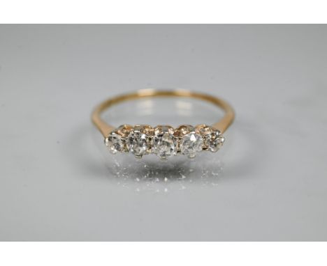 A graduated five stone diamond ring, the old cut diamonds in scroll claw mount, 9ct yellow gold set, size R 1/2  