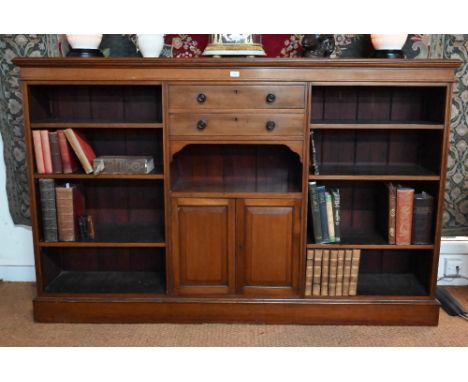 A Victorian mahogany low open bookcase, centred by two long drawers over an open niche and pair cupboards, flanked by four ad