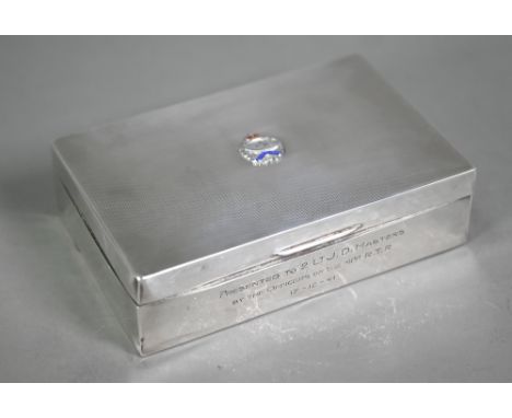 An engine-turned silver cigarette box, with applied enamel Royal Tank Regiment badge and presentation inscription&nbsp; 41st 