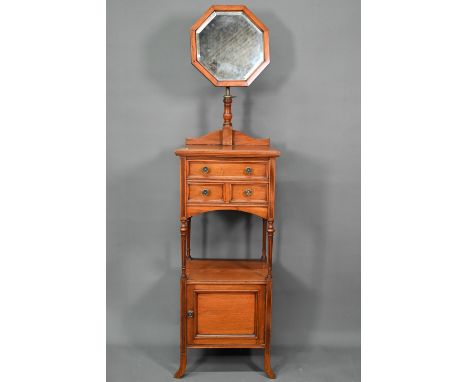 A circa 1900 dressing stand with octagonal framed adjustable mirror over three drawers and open shelf and cupboard on square 