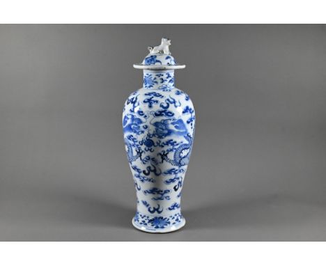 A 19th century Chinese blue and white 'dragon' vase and domed cover with moulded guardian lion finial, the vase of high shoul