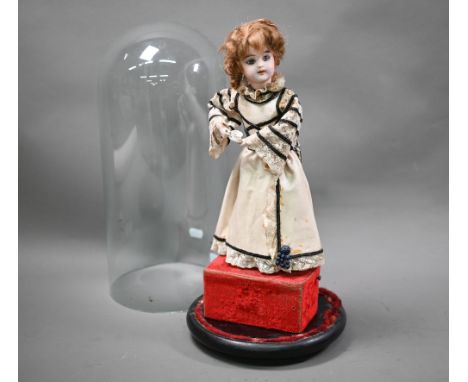 An antique French Jumeau bisque doll automaton by L Lambert, standing and drinking tea, 34 cm high, under a glass dome  