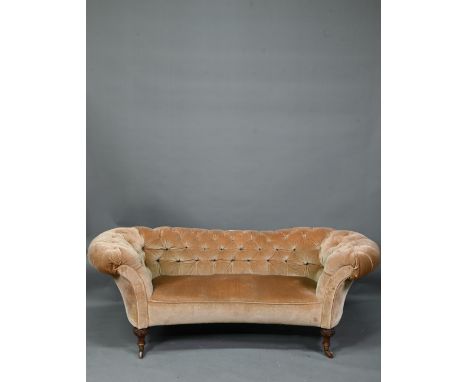 A Victorian button upholstered sofa, raised on moulded and turned walnut front lets, on ceramic castors, 195 cm w x 90 cm x 8