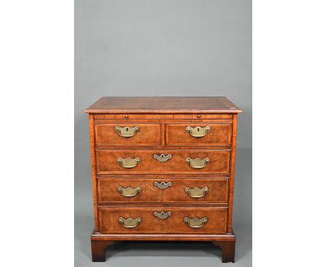A good reproduction George II style feather-banded chest of drawers, the full width brush slide over two short and three long
