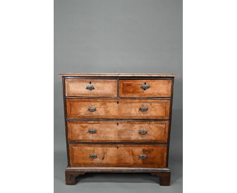 An 18th century cross-banded walnut chest of two short over three long graduated drawers, raised on shaped bracket feet, 100 