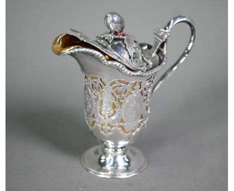 An unusual Victorian silver cream jug, the hinged cover with melon finial, the body ornately pierced and engraved with foliag