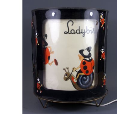 A 1950's metal and celluloid ladybird lamp with rotating inner shade, H. 37cm.