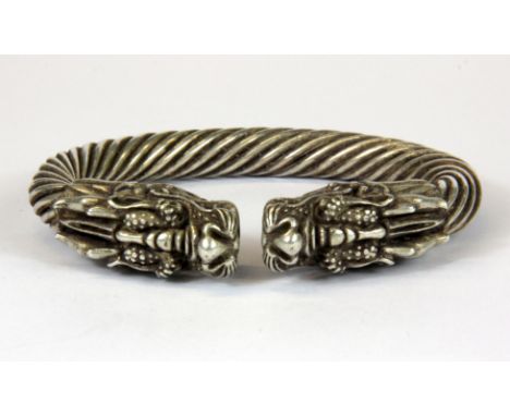 A Chinese heavy white metal dragon bangle, W. 10cm.