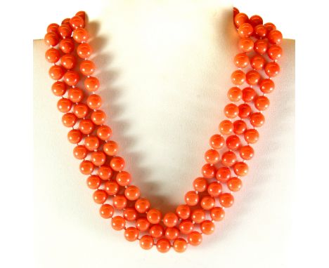 A three row shell bead necklace on a mother of pearl rose shaped clasp.